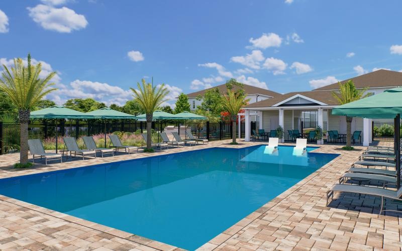 a swimming pool with lounge chairs and umbrellas by a building